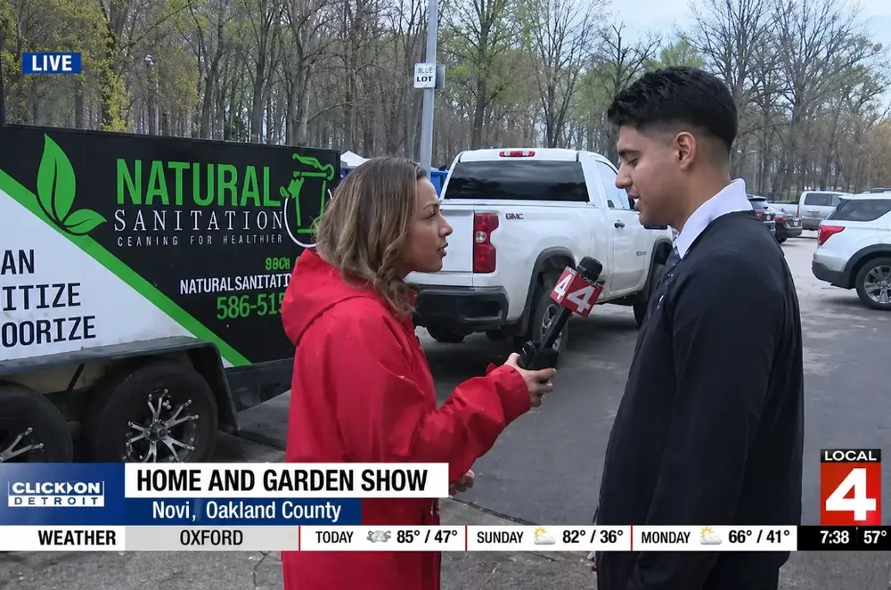 Manny being interviewed by Local 4 News at the Home and Garden Show in Novi, Oakland County, in front of his former company's Natural Sanitation trailer.